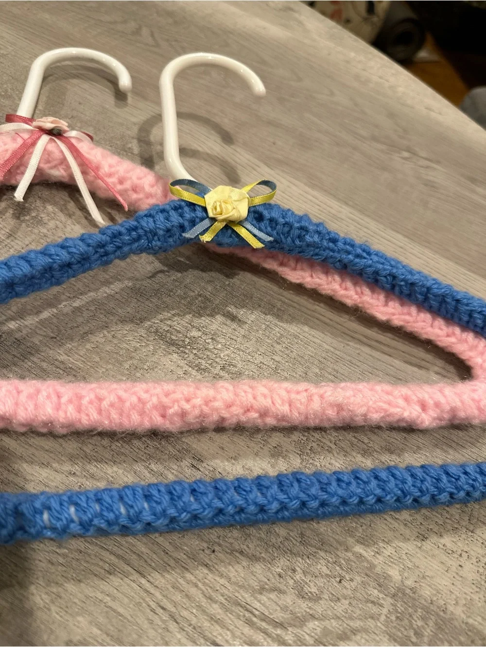 Handmade Pink and Blue Yarn-Covered Closet Hangers with Decorative Bows
